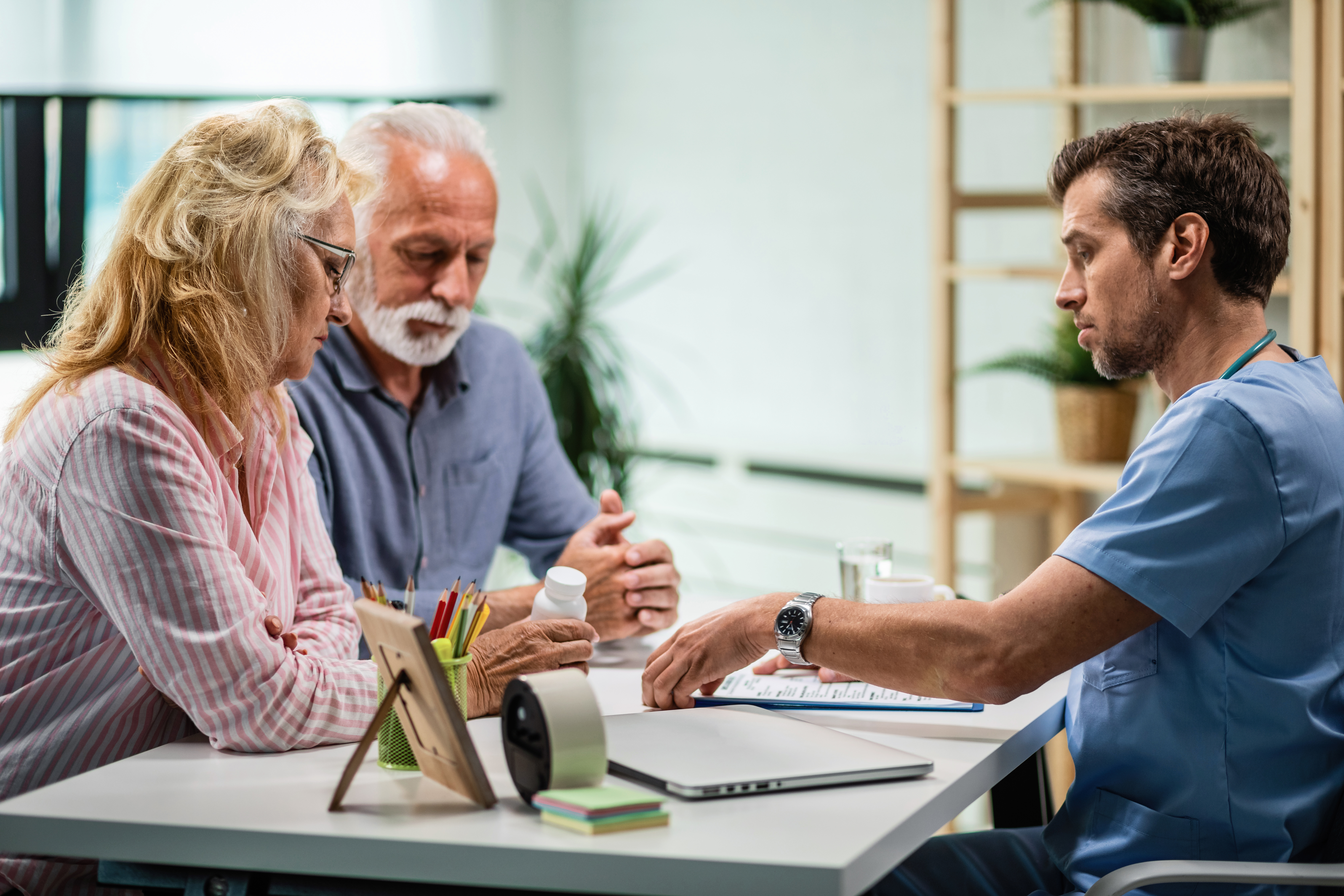 Doctor reviewing a patient's medical records after a delayed specialist referral.