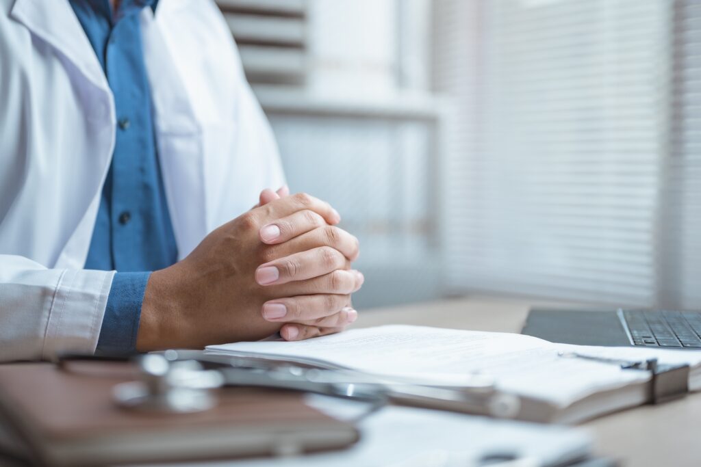 Doctor reviewing patient records after failure to order diagnostic tests.